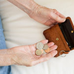 Close up of older woman counting coins